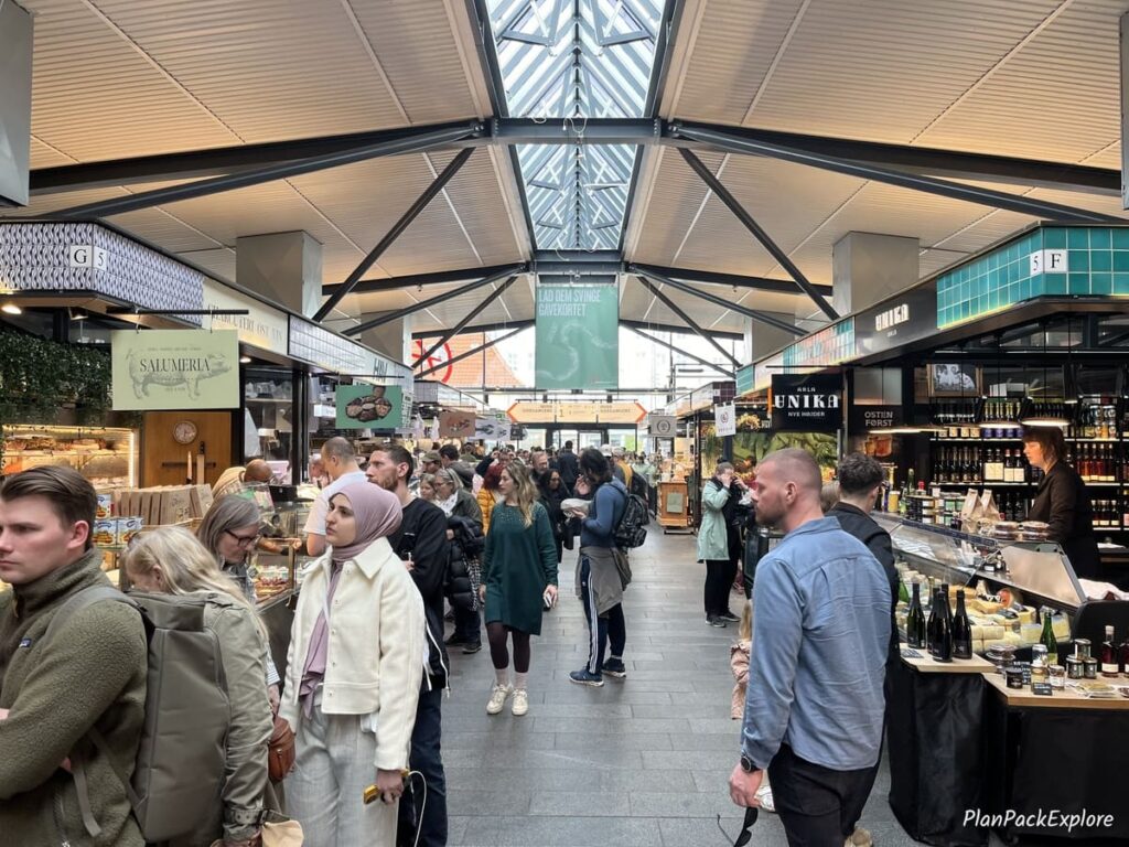 Food stalls inside of Torvehallerne food hall in copenhagen denmark.