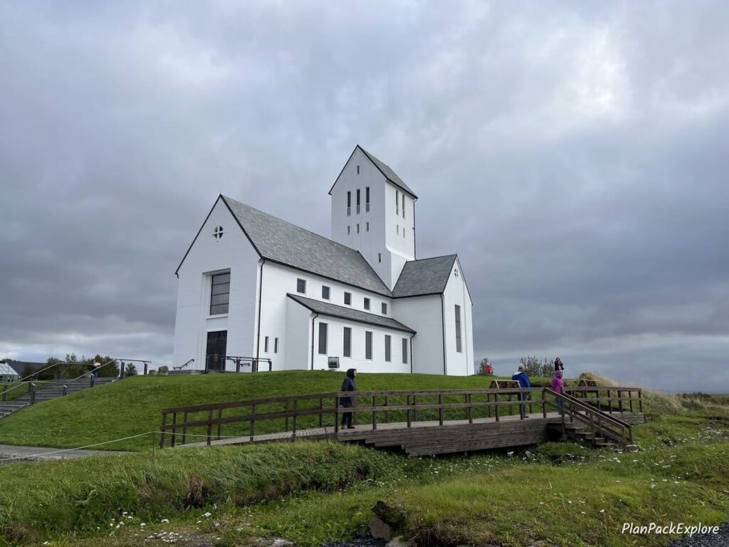 A white church with a black roof, called Skalholt Cathedral, in Iceland.