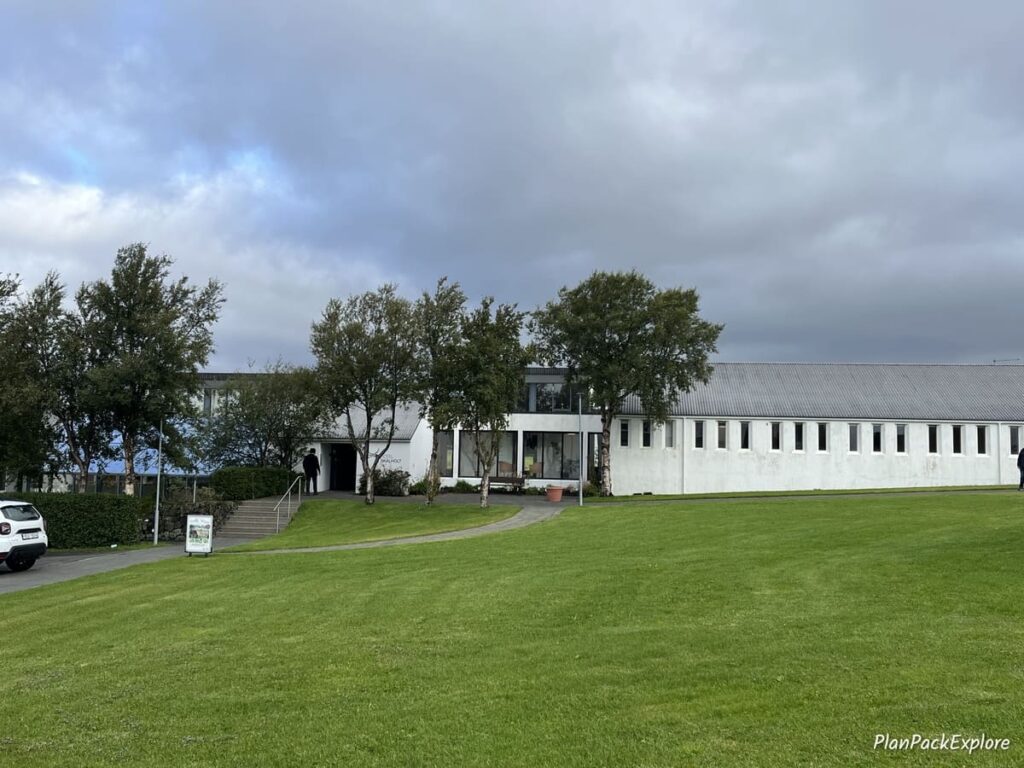 A distant view of single floor, white building of the Hotel Skalholt in Iceland.