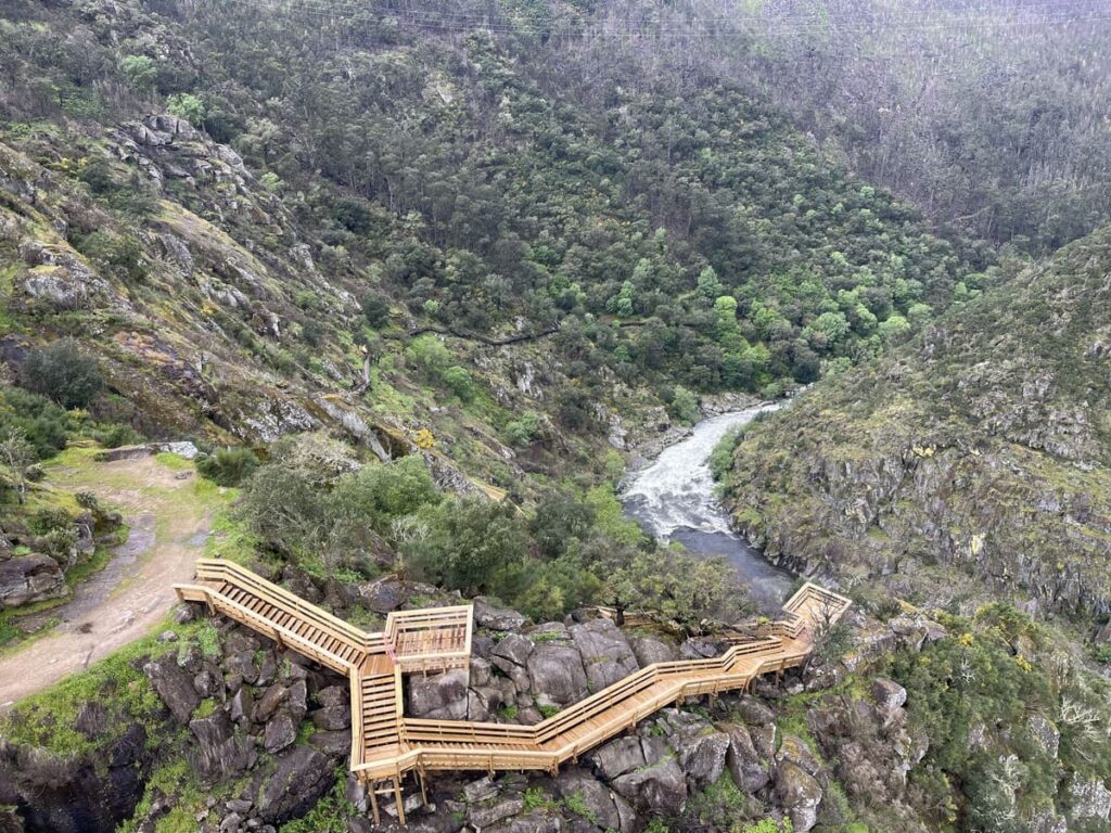 A wooden staircase leading down towards the river along Paiva Walkways in Portugal.