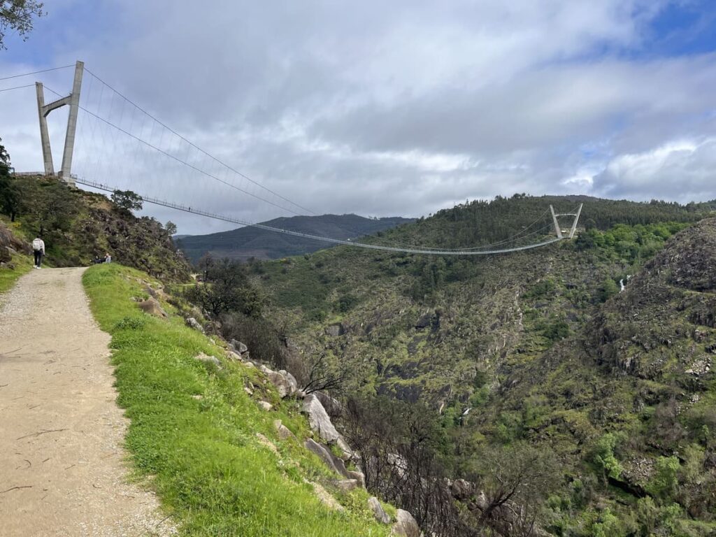 A view of a steel suspension bridge called 516 Arouca Bridge in Portugal from a hiking trail.