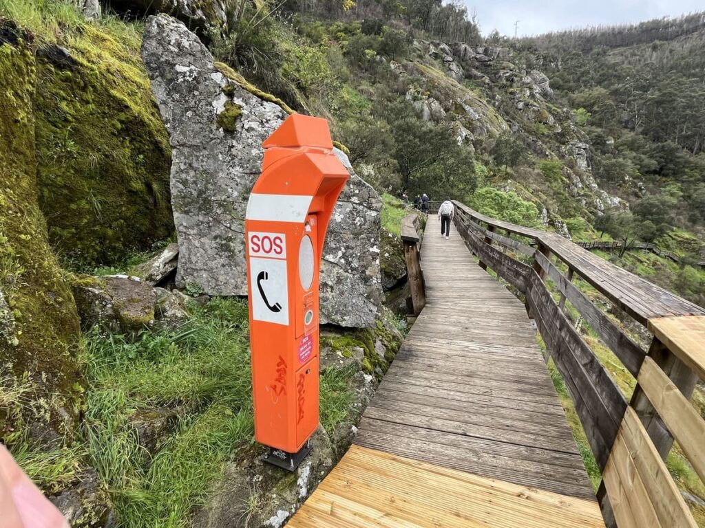 An orange emergency phone on Passadicos do Paiva trail in Portugal.