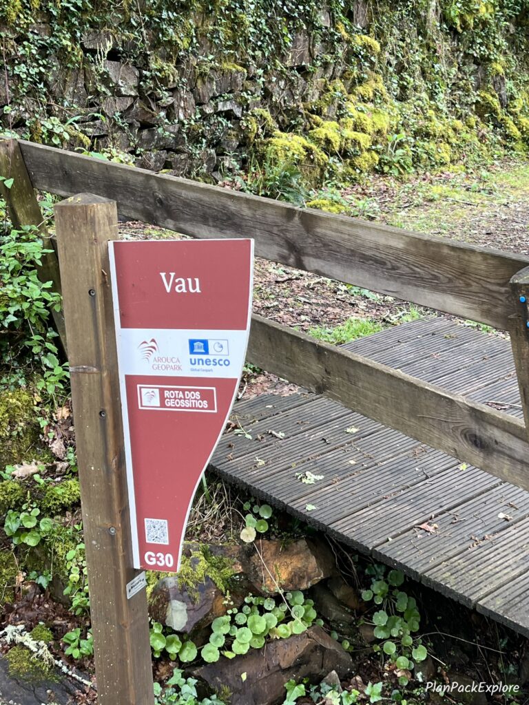 A red sign stating the location of Vau - a stop on the Paiva Walkways trail in Portugal.