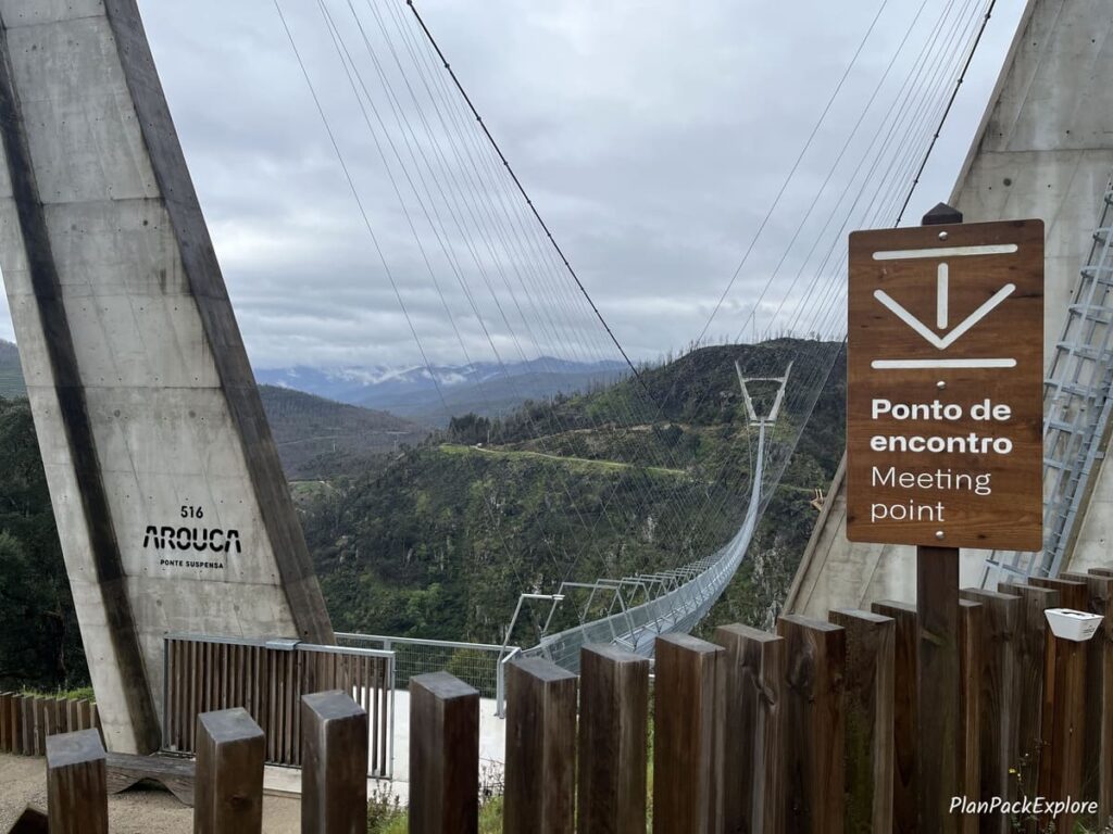 A brown sign for a meeting point near the 516 arouca suspension bridge in Portugal.