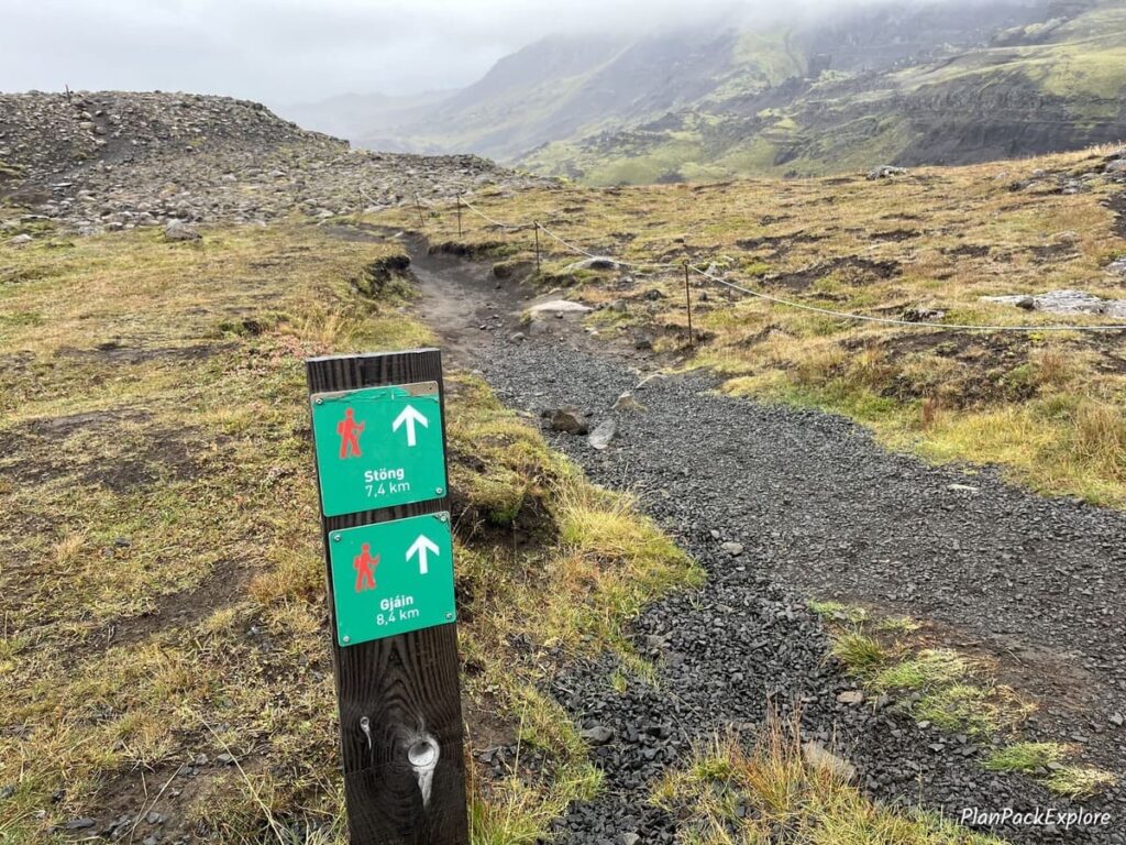 Green trail markers for hiking trails starting at Haifoss Waterfall in Thjorsardalur Valley, Iceland.