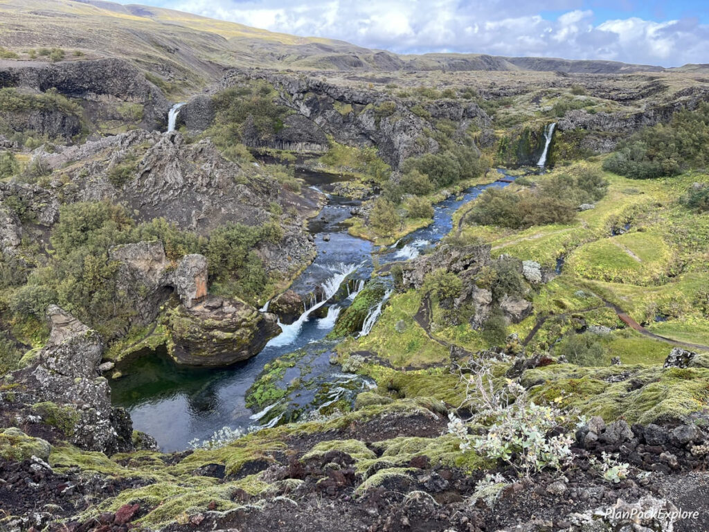 A lush green valley called Gjain with waterfalls and ponds, in Thjorsardalur Valley, Iceland.