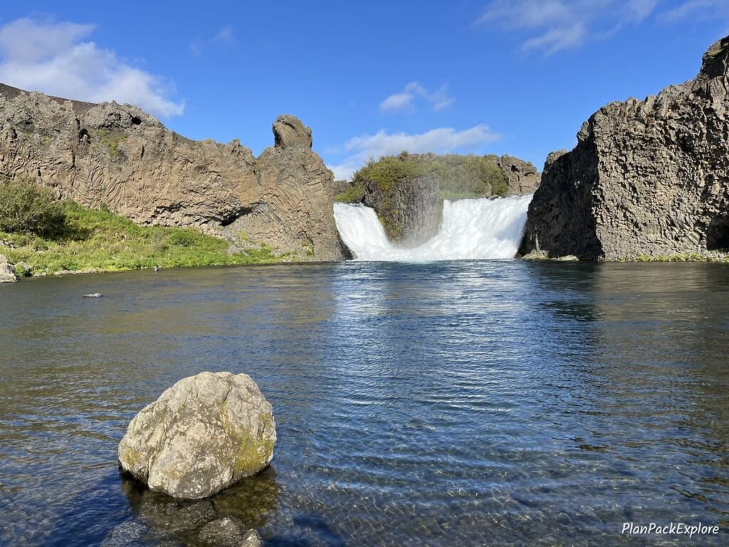 A short wide double cascade waterfall by a lake in Thjorsardalur Valley in Iceland.