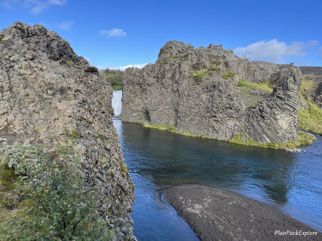 Large volcanic rock structure with twisted basalt columns standing in a lake in Thjorsardalur Valley in Iceland.