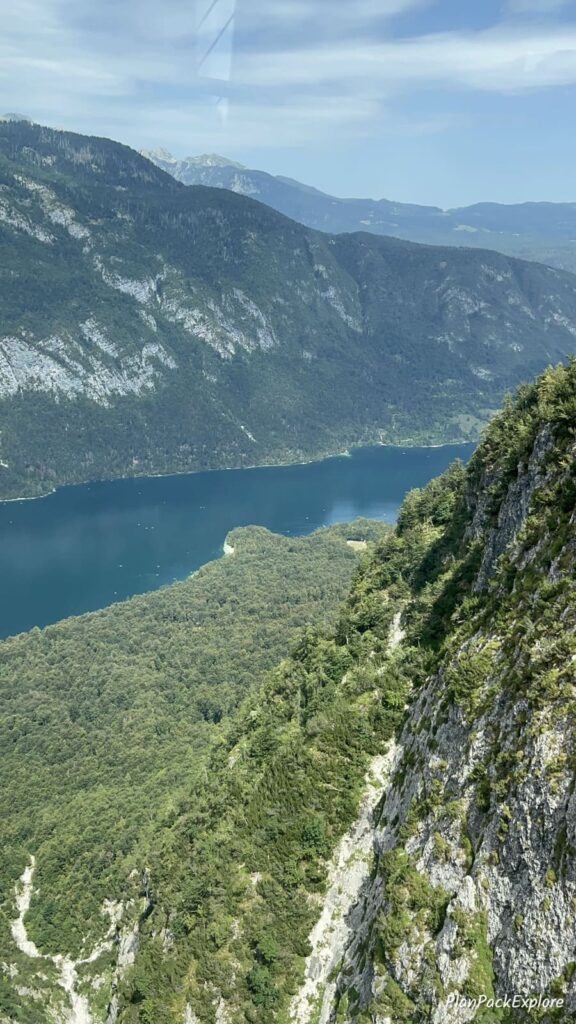 An aerial view of a blue lake Bohinj surrounded by Julian Alps from Vogel Cable Car in Slovenia.