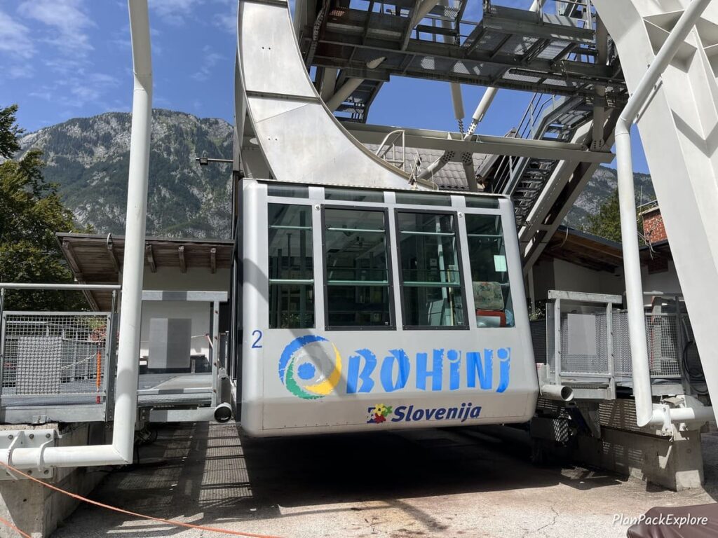 A large Cable car with blue letters spelling Bohinj in Slovenia.