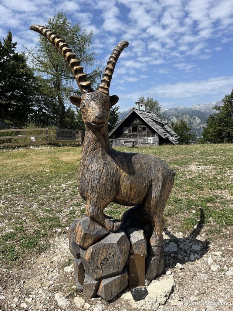 A wooden goat sculpture on top of Vogel Viewpoint in Slovenia.