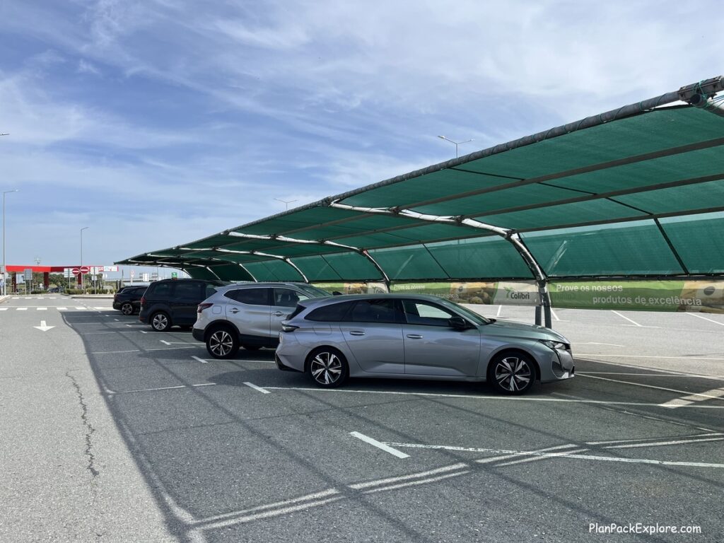 A green canopy providing shade for cars in a rest area in Portugal.