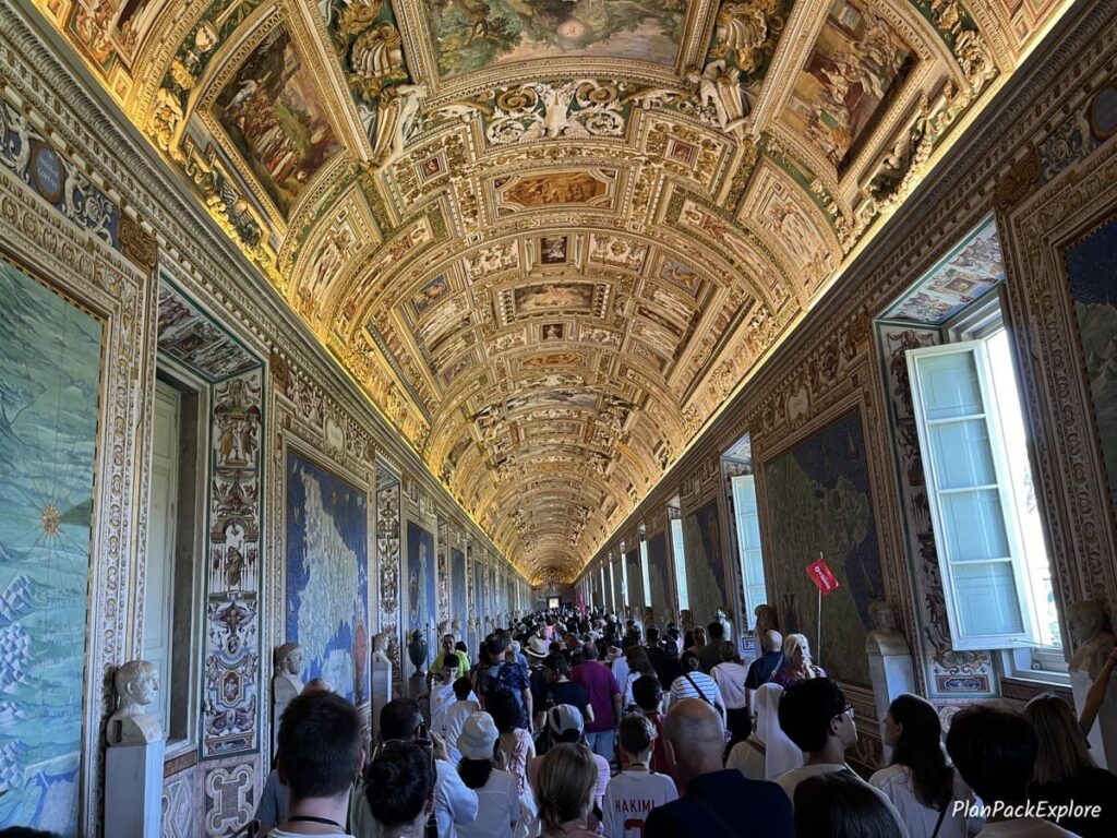 An ornamental ceiling and historic maps on the walls of the Vatican Museums in Italy.