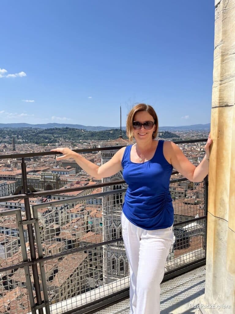 A woman standing at the observation deck of the Florence Duomo in Italy.