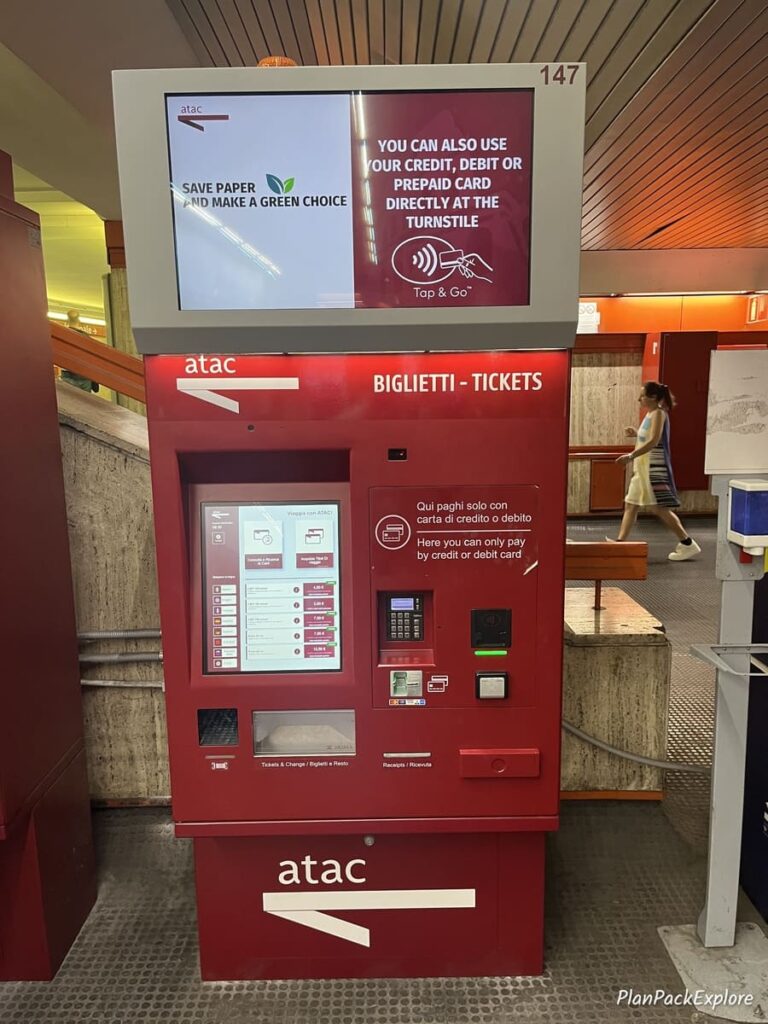 A red self-service ticket kiosk at a metro station in Rome.