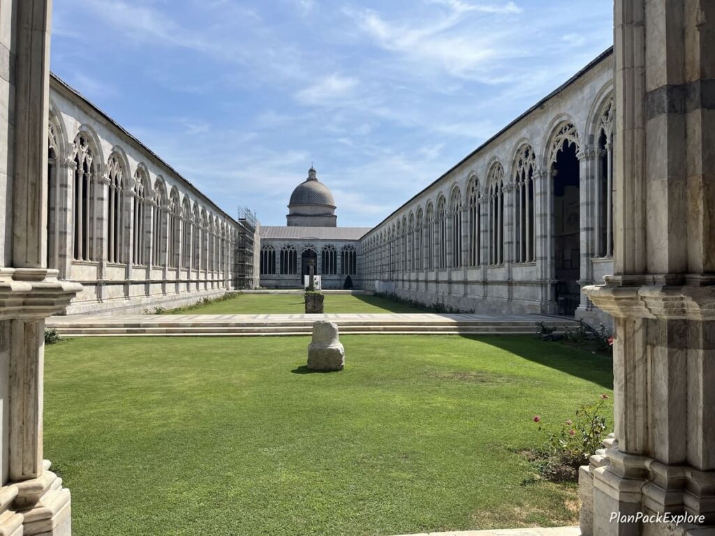 A grassy center courtyard of Camposanto in Pisa, Italy.