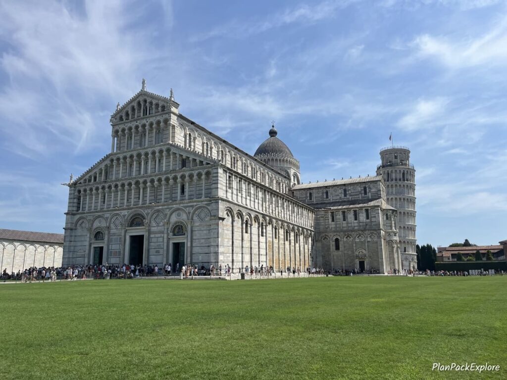 A view of the Cathedral in Pisa, Italy, with a leaning tower in the background.