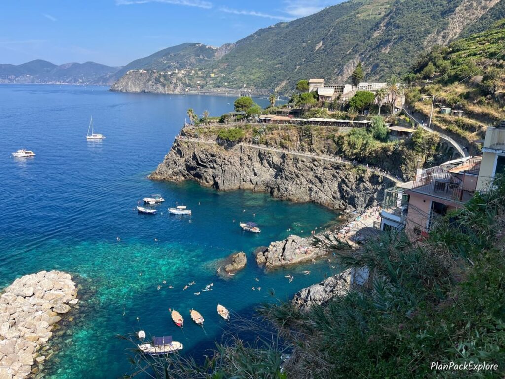 A panoramic view of the Ligurian Sea and the mountainside vineyards of Cinque Terre, Italy.