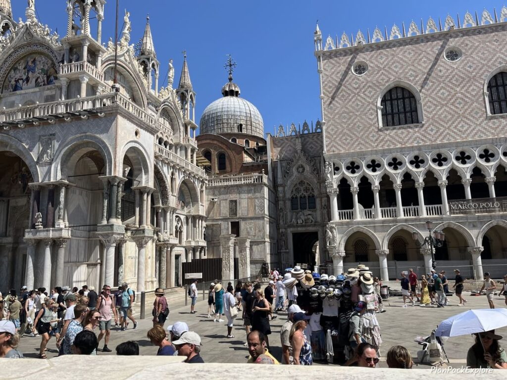 A crowd of people in front of the church in Piazza San Marco in Venice, Italy.