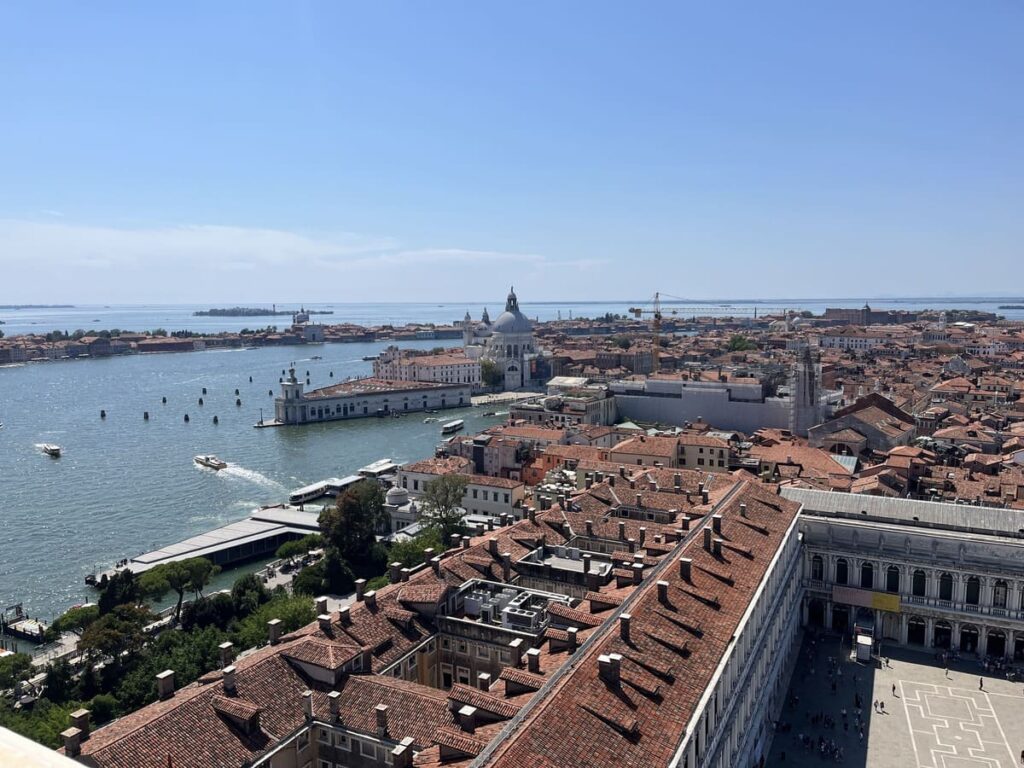A view of rooftops and the panorama of Venice, as well as the Venetian Lagoon in Italy.