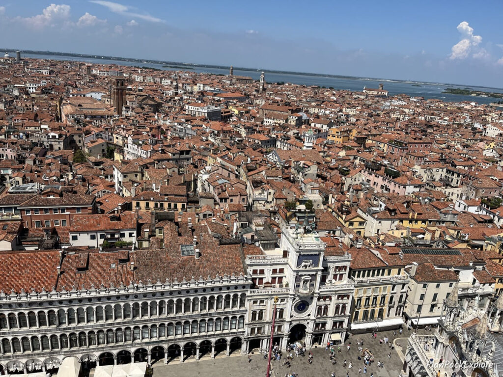 An aerial view of red rooftops and Piazza San Marco in Venice, Italy.