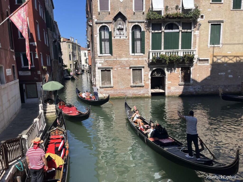 Gondolas on a canal between historic buildings in Venice, Italy