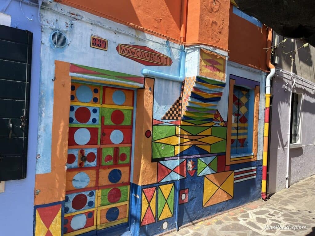 A brightly painted house with geometric patterns, known as Casa Bepi, on the Island of Burano in Italy.