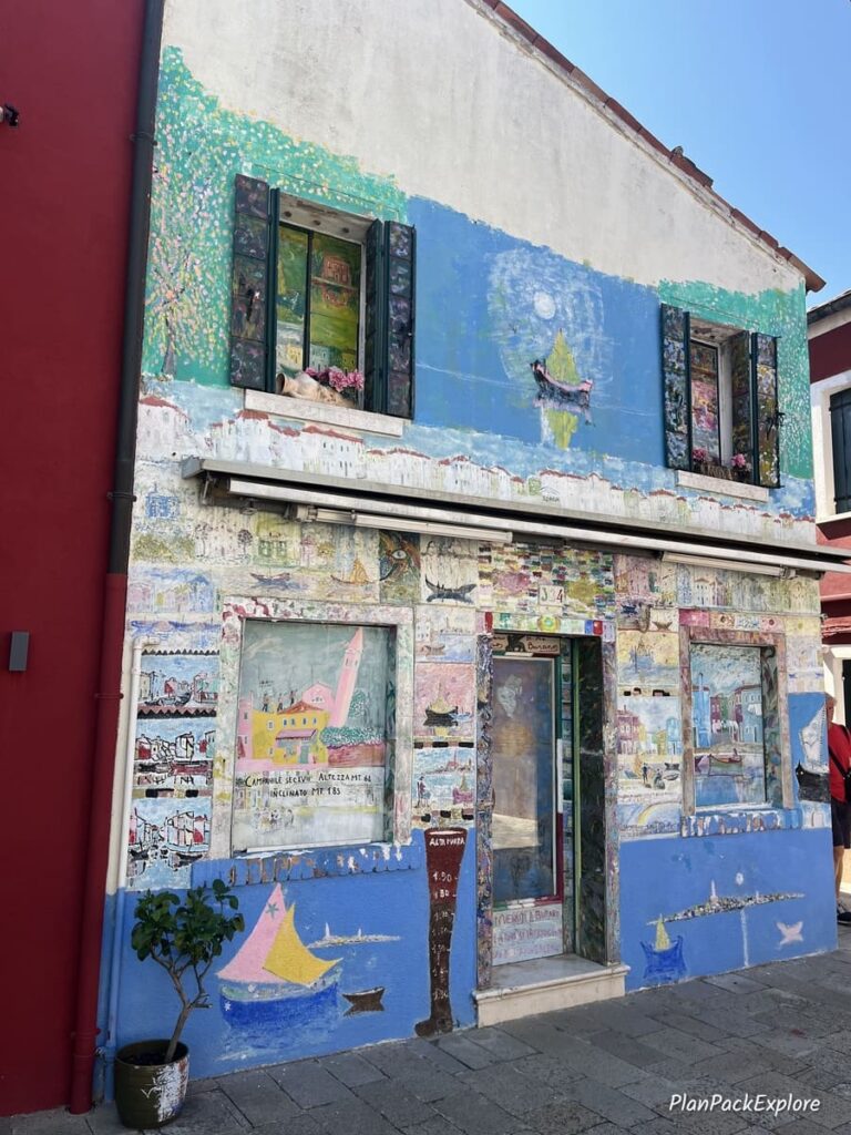 A house painted with aquatic-themed murals on Burano in Italy.