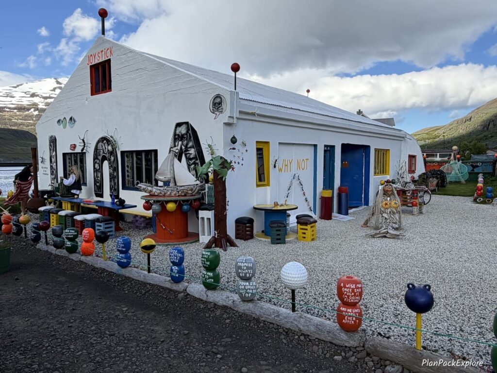 Colorful nautical theme art displayed outside a house by the water in Seydisfjordur, Iceland.