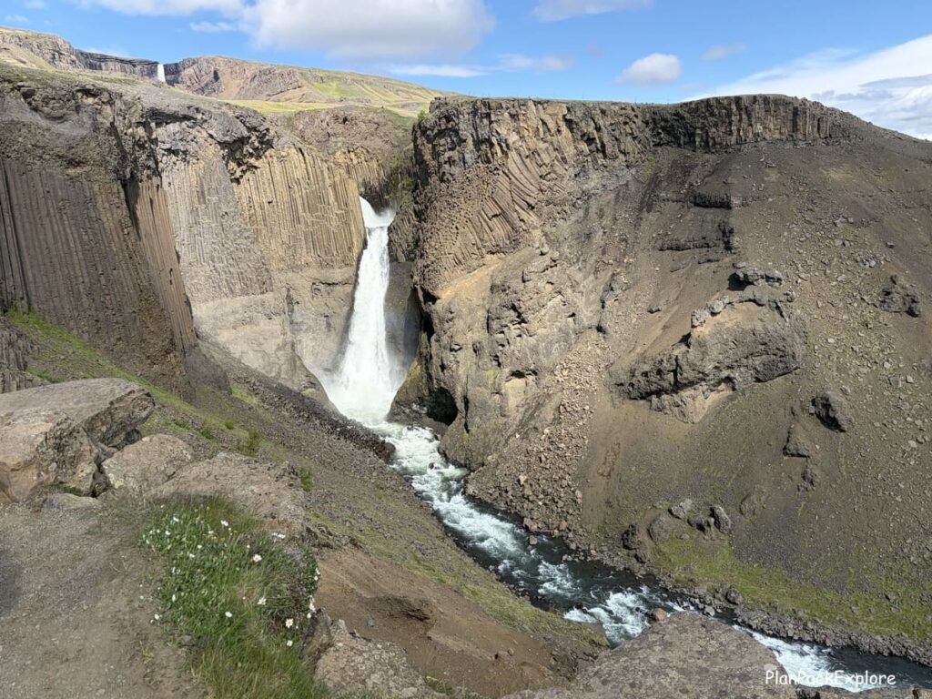 A tall waterfall set in a basalt cove near Hengifoss, Iceland.