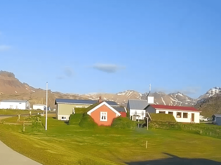 A small red, turf-covered farmhouse by the road to Borgarfjordur Eystri in Iceland.