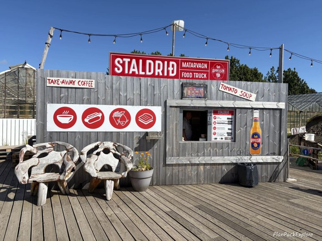 A wooden food stand with two chairs in front on the Silver Circle in Iceland.
